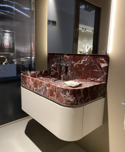 Ella est une réinterprétation du lavabo classique en pierre, où tradition et modernité se rencontrent. Chaque détail a été soigneusement pensé pour une harmonie parfaite entre forme et fonction. Plan de travail avec vasque intégrée en marbre rosso lepanto, meuble haut 1 tiroir.
